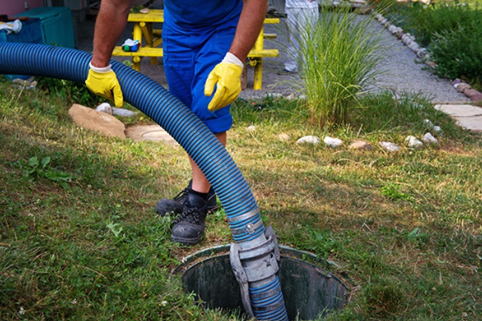 A man showing how to pump septic tank